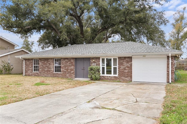 ranch-style home featuring a garage and a front lawn