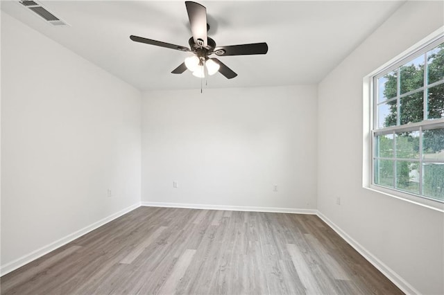 empty room with hardwood / wood-style flooring and ceiling fan