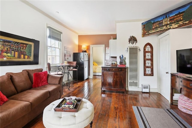 living room with crown molding and dark wood-type flooring