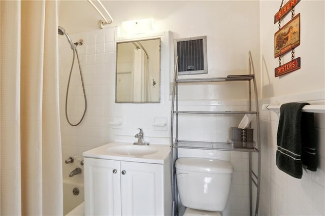 full bathroom featuring tile walls, shower / tub combo with curtain, vanity, and toilet