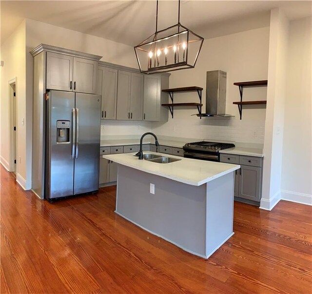 kitchen featuring range with gas stovetop, island range hood, sink, stainless steel fridge with ice dispenser, and dark wood-type flooring