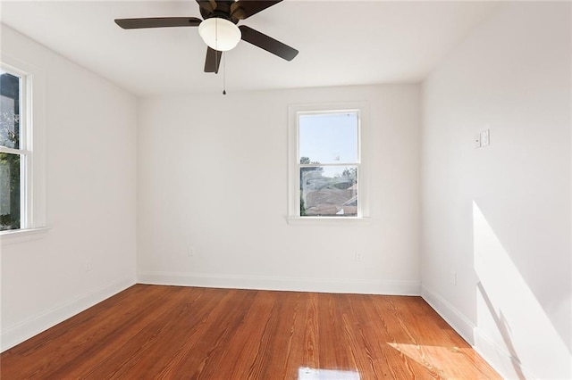 empty room featuring a ceiling fan, light wood-style floors, and baseboards