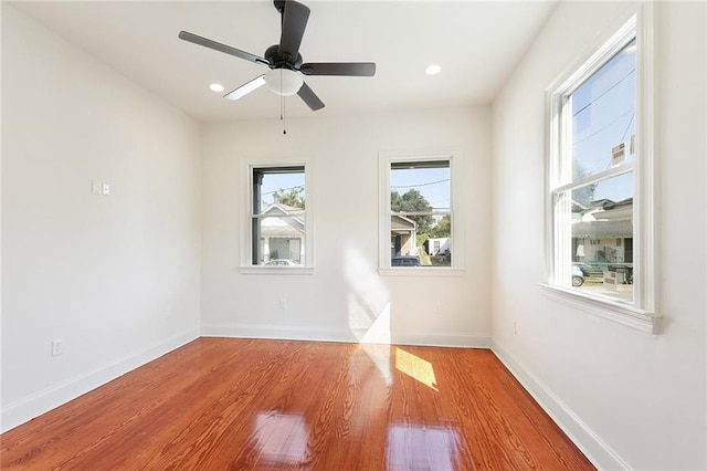 spare room with light wood-type flooring and ceiling fan