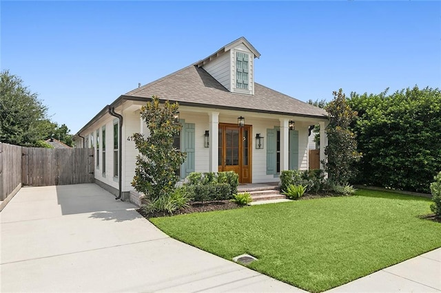 view of front of property featuring a porch, fence, concrete driveway, roof with shingles, and a front lawn