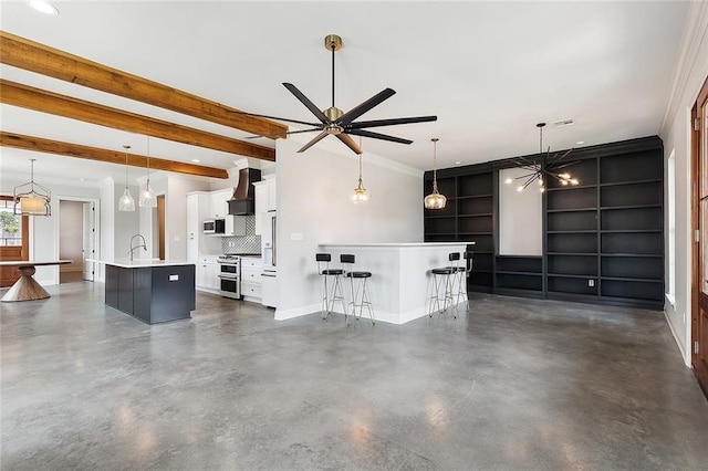 unfurnished living room featuring a sink, beam ceiling, baseboards, and concrete flooring