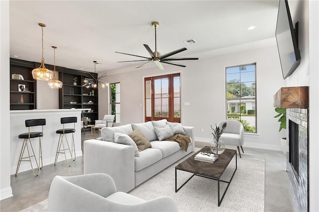 417 Nursery Ave, Metairie, LA 70005 - living area with visible vents, crown molding, baseboards, a fireplace, and concrete flooring