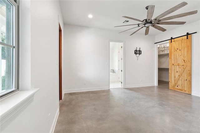 unfurnished room featuring a barn door, baseboards, ceiling fan, concrete floors, and recessed lighting