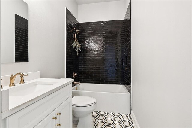 full bathroom featuring toilet, tiled shower / bath combo, and vanity