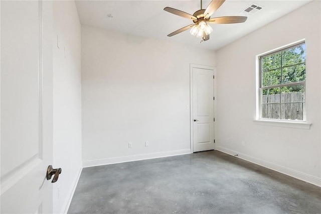 empty room with a ceiling fan, visible vents, baseboards, and concrete flooring