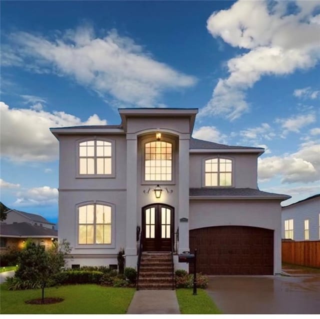 view of front of property with a garage, a front yard, and french doors