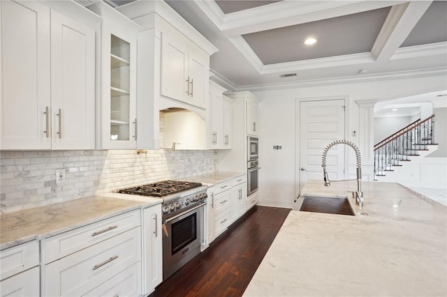 kitchen featuring high end stove, white cabinetry, light stone counters, and dark hardwood / wood-style floors