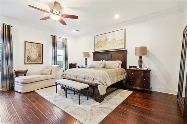 bedroom featuring dark hardwood / wood-style floors, ceiling fan, and crown molding