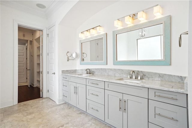 bathroom featuring crown molding and vanity