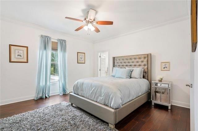 bedroom featuring dark hardwood / wood-style floors, ceiling fan, and crown molding