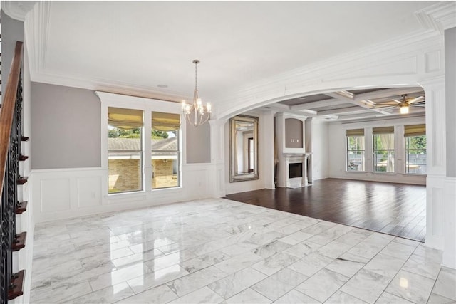 unfurnished living room with ornamental molding, a wealth of natural light, and coffered ceiling