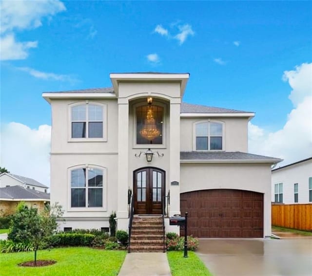 view of front of home featuring a garage, a front yard, and french doors