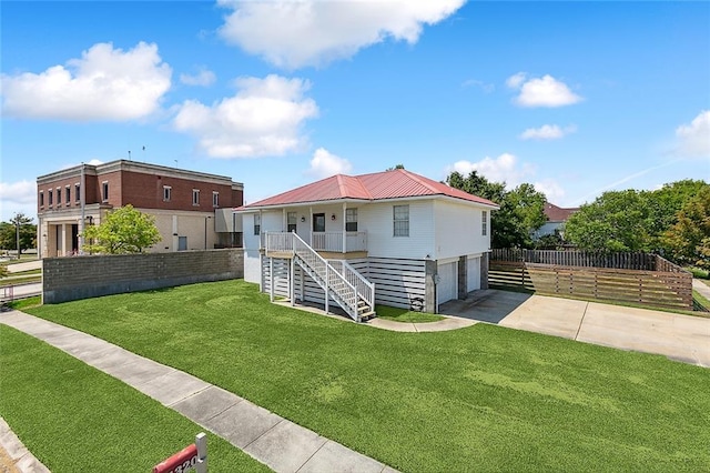 back of property featuring a lawn and a garage