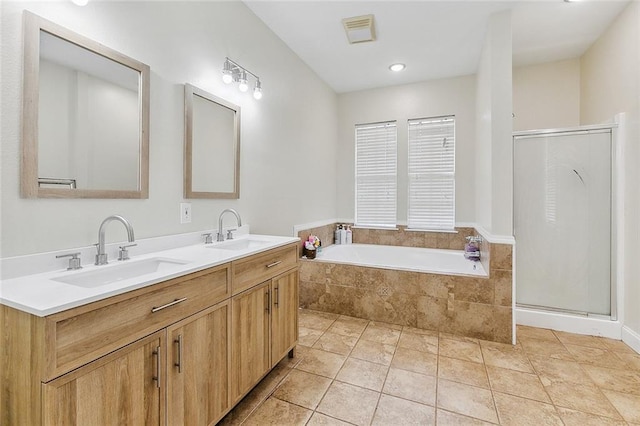 bathroom featuring plus walk in shower, tile patterned floors, and vanity