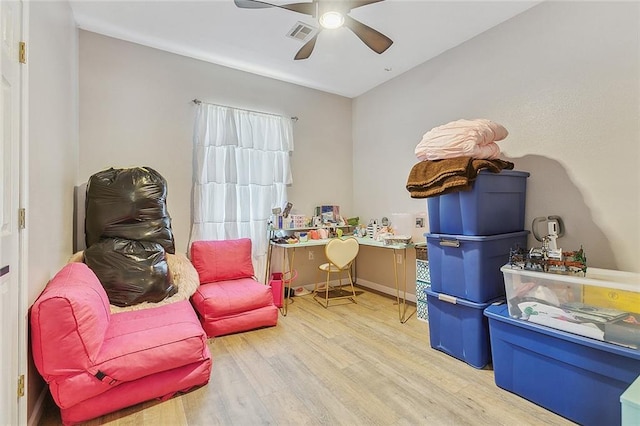 living area with ceiling fan and light wood-type flooring