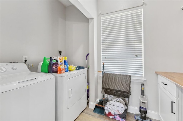 laundry area featuring light hardwood / wood-style flooring and washing machine and clothes dryer