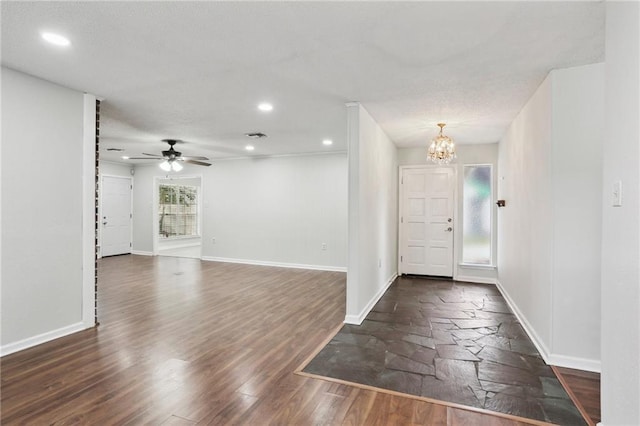 entrance foyer featuring dark hardwood / wood-style floors and ceiling fan with notable chandelier