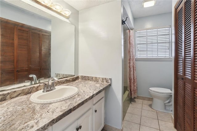 full bathroom featuring a textured ceiling, toilet, vanity, shower / tub combo with curtain, and tile patterned flooring