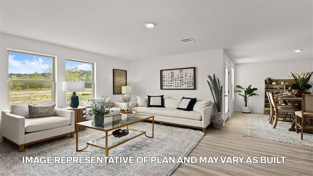 living room with recessed lighting, wood finished floors, visible vents, and baseboards