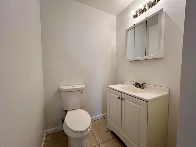 bathroom with vanity, toilet, and tile patterned flooring