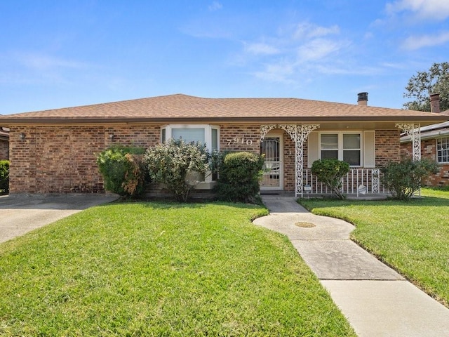 ranch-style home with a porch and a front lawn