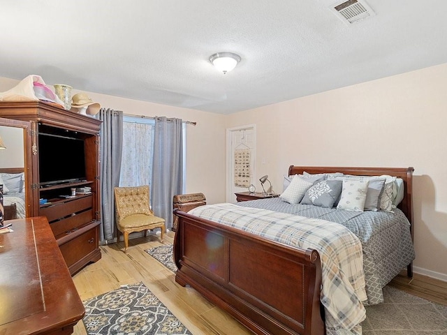 bedroom with light wood-type flooring