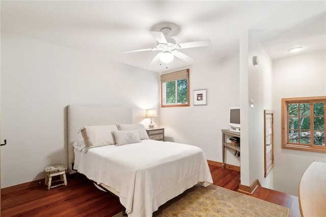 bedroom with ceiling fan and dark hardwood / wood-style floors