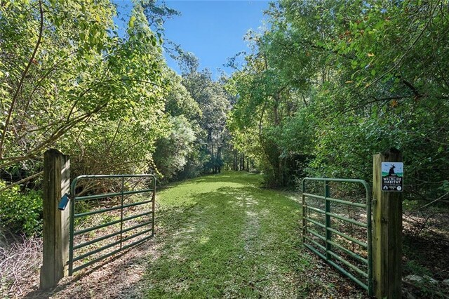 view of gate featuring a lawn