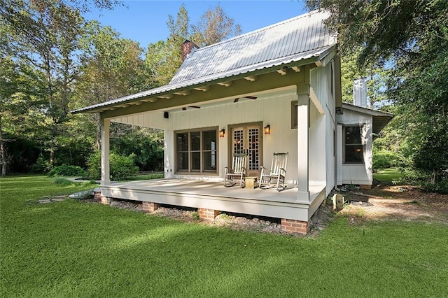 rear view of house with a yard and ceiling fan