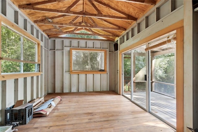 unfurnished sunroom featuring vaulted ceiling