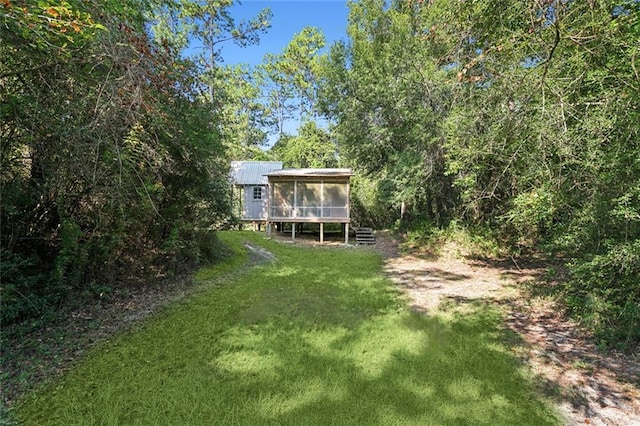 view of yard featuring a sunroom