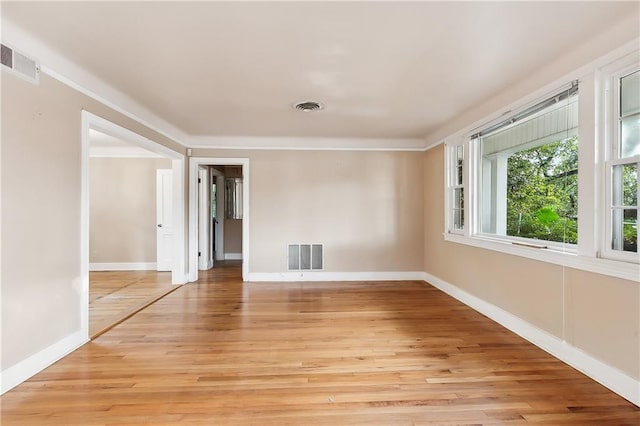 spare room featuring light hardwood / wood-style flooring