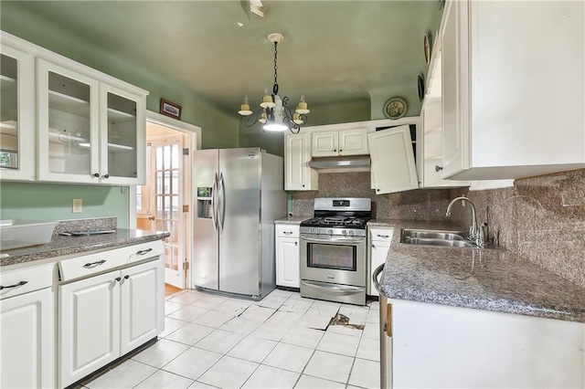 kitchen with white cabinets, stainless steel appliances, hanging light fixtures, and sink