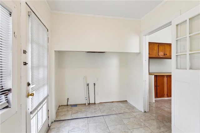 doorway to outside featuring ornamental molding