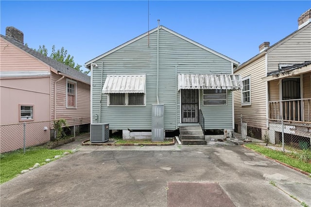 rear view of house with central AC unit