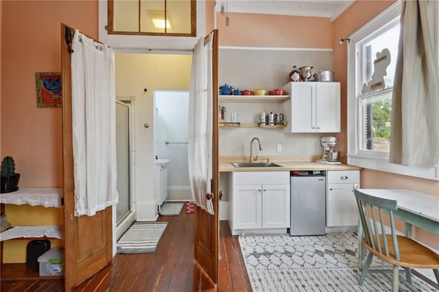 kitchen with sink, dark wood-type flooring, and white cabinetry