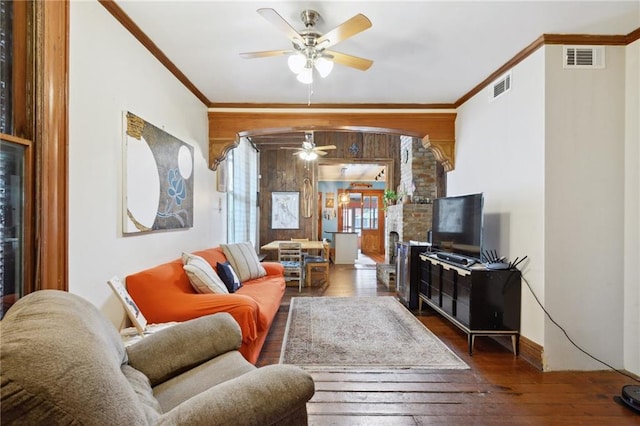 living room featuring ceiling fan, crown molding, dark hardwood / wood-style floors, and plenty of natural light