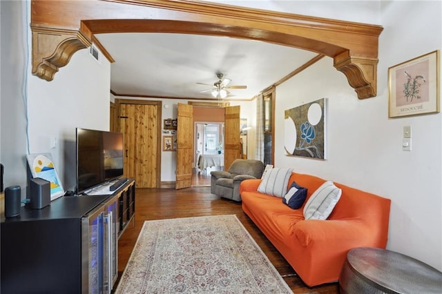 living room with ceiling fan, crown molding, and dark hardwood / wood-style flooring