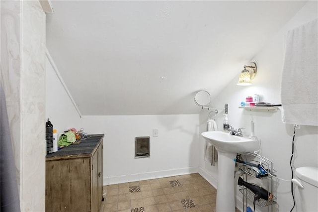 bathroom featuring vaulted ceiling and toilet