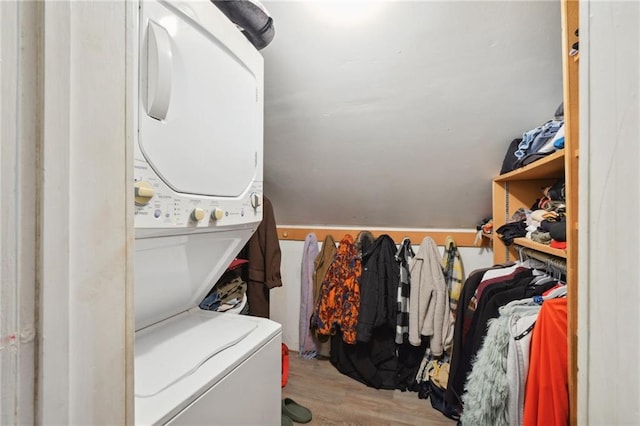 interior space featuring light wood-type flooring and stacked washing maching and dryer