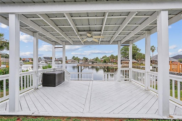 wooden terrace featuring a water view and ceiling fan