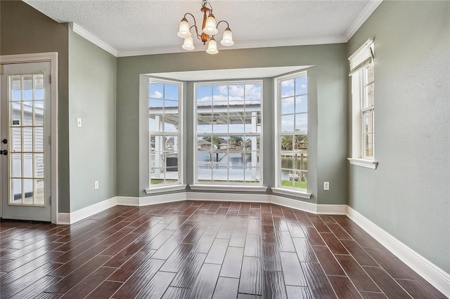 interior space featuring dark hardwood / wood-style flooring, a chandelier, crown molding, and a textured ceiling