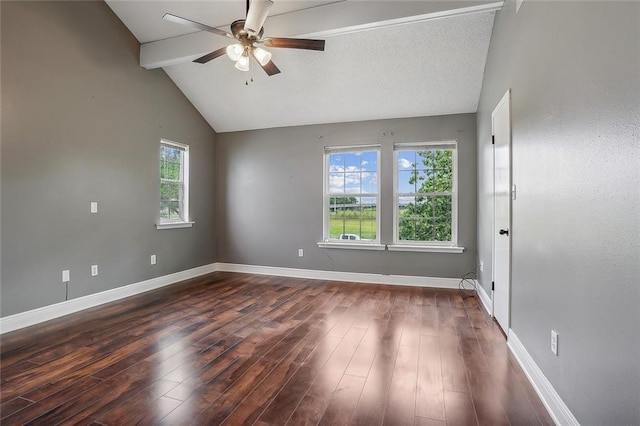 unfurnished room with a wealth of natural light, dark wood-type flooring, ceiling fan, and lofted ceiling with beams