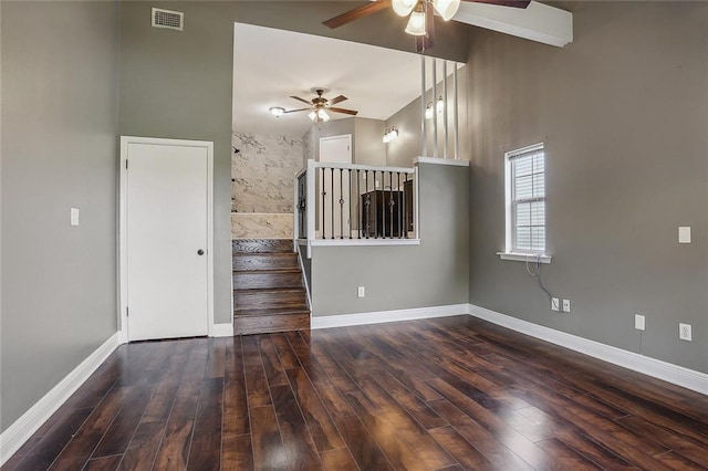 unfurnished living room featuring ceiling fan, dark hardwood / wood-style floors, and high vaulted ceiling