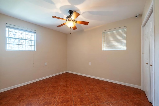 unfurnished bedroom with ceiling fan and a closet