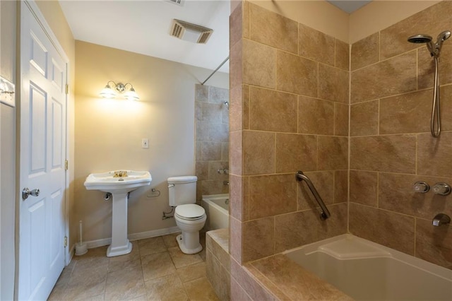 3306 Trafalgar St, New Orleans, LA 70112 - bathroom with shower / bathing tub combination, toilet, visible vents, tile patterned floors, and baseboards